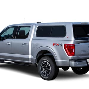 100XR-FO-F150-2021-Silver-3-4-Rear-Dr-Closed-WhiteBG LEER 100XR fiberglass truck cap custom installed on a modern pickup truck at Accessory World Customs in Hialeah
